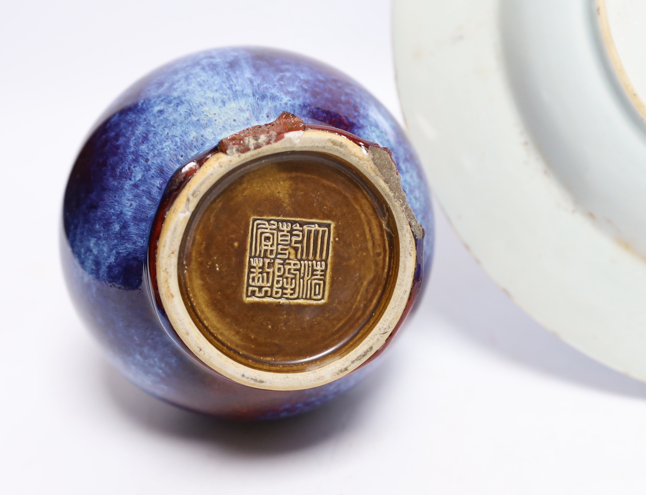 A group of Chinese ceramics including a flambé vase, an 18th century blue and white floral plate and a similar lid, 25cm diameter